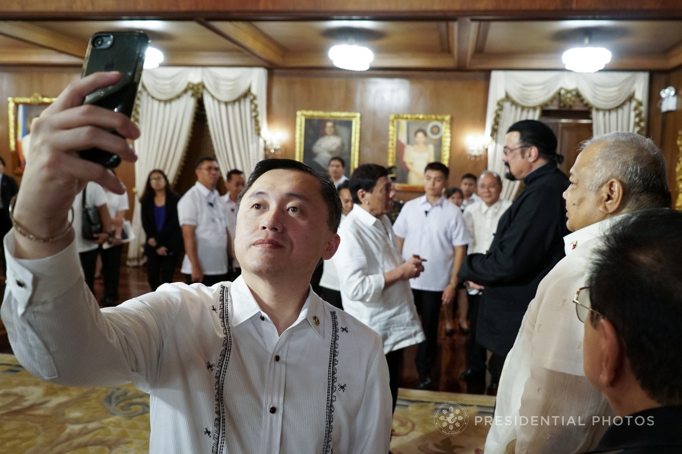 Special Assistant to the President Christopher Lawrence Go takes a selfie while President Rodrigo Roa Duterte chats with Actor Steven Seagal who met with the President in Malacañan Palace on October 12, 2017. KING RODRIGUEZ/PRESIDENTIAL PHOTO