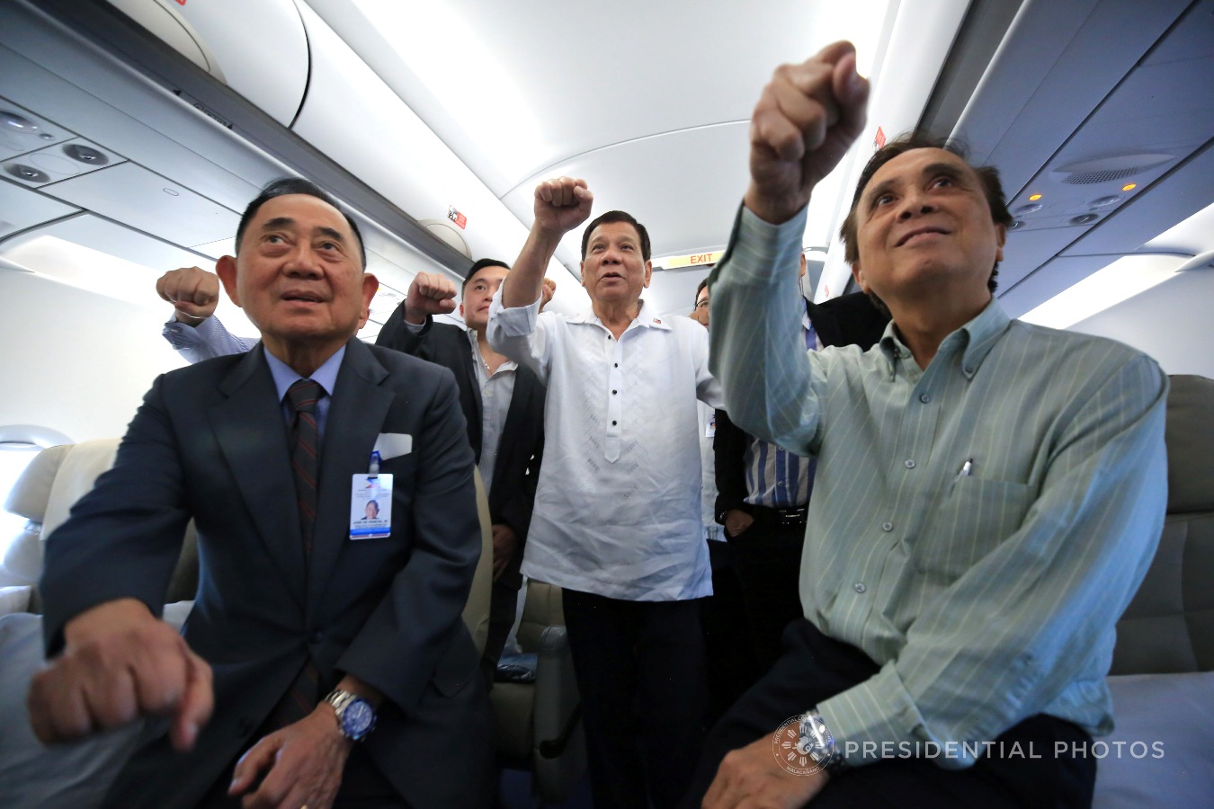 President Rodrigo Roa Duterte does his signature pose with the members of his delegation to the 2017 APEC Economic Leaders' Meeting while on board the Philippine Airlines chartered flight bound for Vietnam on November 8, 2017. ALBERT ALCAIN/PRESIDENTIAL PHOTO 