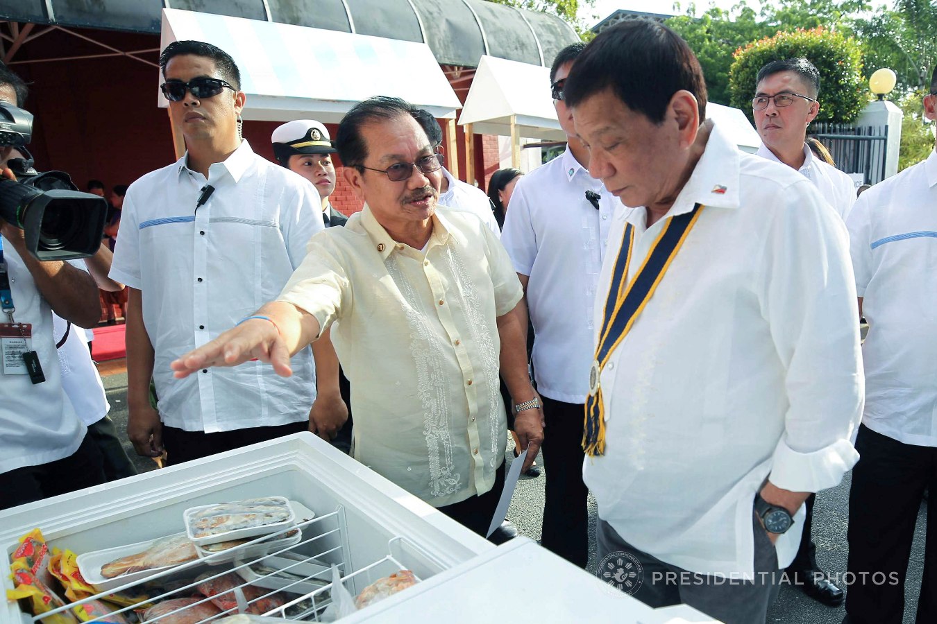 President Rodrigo Roa Duterte is briefed by Agriculture Secretary Emmanuel Piñol as he visits one of the TienDA Fisherfolks' booths during the launching of the Karne, Isda Supply Suporta sa Masa at Ekonomiya (KISS ME) Project at Fort Andres Bonifacio in Taguig City on November 7, 2017. ACE MORANDANTE/PRESIDENTIAL PHOTO