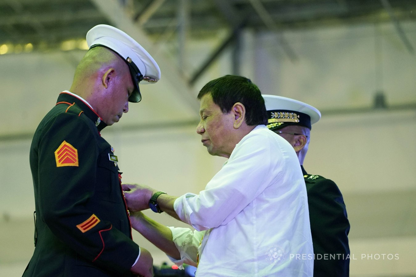 President Rodrigo Roa Duterte confers the Order of Lapu-Lapu Kamagi Medal and the Gold Cross Medal on Sgt. Richard Anding during the 67th Birthday celebration of the Philippine Marine Corps at the Bonifacio Naval Station in Fort Bonifacio, Taguig City on November 7, 2017. Anding was hailed for his gallantry during a battle against the terrorists from the Maute Group. KING RODRIGUEZ/PRESIDENTIAL PHOTO