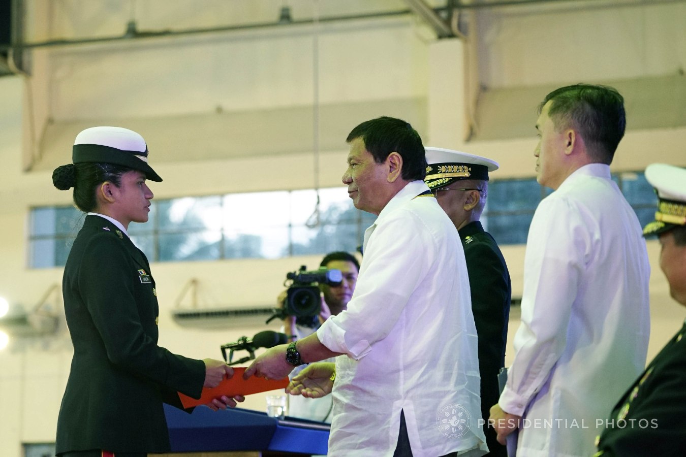 President Rodrigo Roa Duterte confers the Order of Lapu-Lapu Kamagi Medal and the Bronze Cross Medal on 2Lt. Loraine Torreña during the 67th Birthday celebration of the Philippine Marine Corps at the Bonifacio Naval Station in Fort Bonifacio, Taguig City on November 7, 2017. Torreña was hailed for her acts of heroism as member of the 75th Marine Maintenance Company. KING RODRIGUEZ/PRESIDENTIAL PHOTO