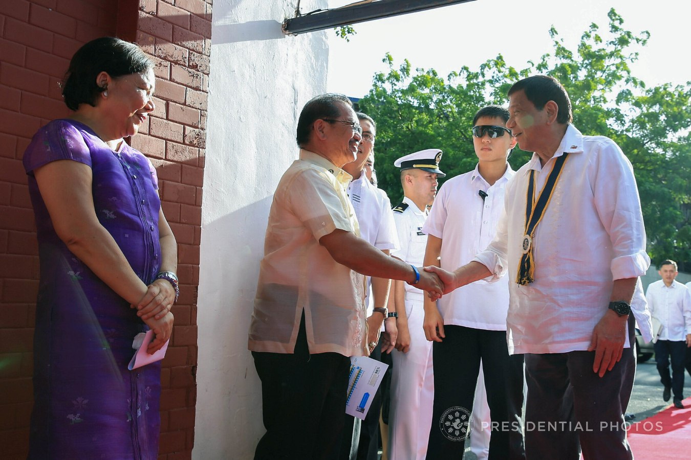 President Rodrigo Roa Duterte is welcomed by Agriculture Secretary Emmanuel Piñol upon his arrival at the Fort Andres Bonifacio in Taguig City for his attendance to the launching of the Karne, Isda Supply Suporta sa Masa at Ekonomiya (KISS ME) Project on November 7, 2017. Also in the photo is Senator Cynthia Villar. ALBERT ALCAIN/PRESIDENTIAL PHOTO