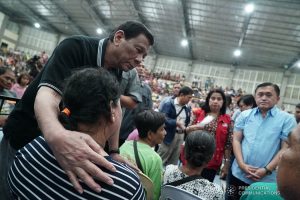 President Rodrigo Roa Duterte sympathizes with the victims who lost their loved ones in a landslide in Naga City, Cebu. The President visited the victims who are currently taking shelter at the Enan Chiong Activity Center (ECAC) on September 21, 2018. Joining the President are Department of Social Welfare and Development (DSWD) Acting Secretary Virginia Orogo and Secretary Christopher Lawrence 'Bong' Go of the Office of the Special Assistant to the President. KING RODRIGUEZ/PRESIDENTIAL PHOTO