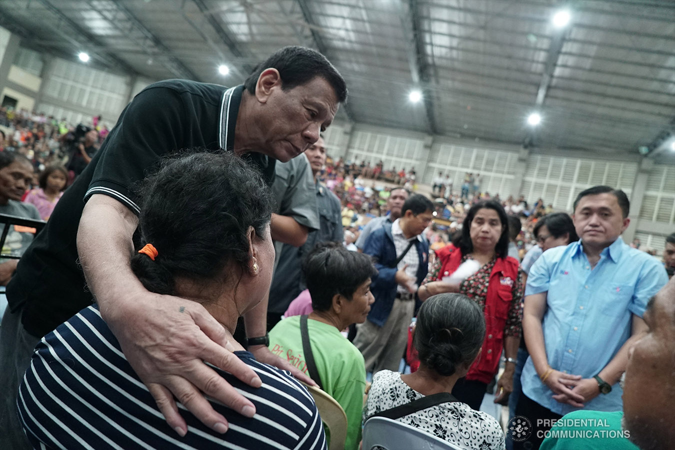 President Rodrigo Roa Duterte sympathizes with the victims who lost their loved ones in a landslide in Naga City, Cebu. The President visited the victims who are currently taking shelter at the Enan Chiong Activity Center (ECAC) on September 21, 2018. Joining the President are Department of Social Welfare and Development (DSWD) Acting Secretary Virginia Orogo and Secretary Christopher Lawrence 'Bong' Go of the Office of the Special Assistant to the President. KING RODRIGUEZ/PRESIDENTIAL PHOTO