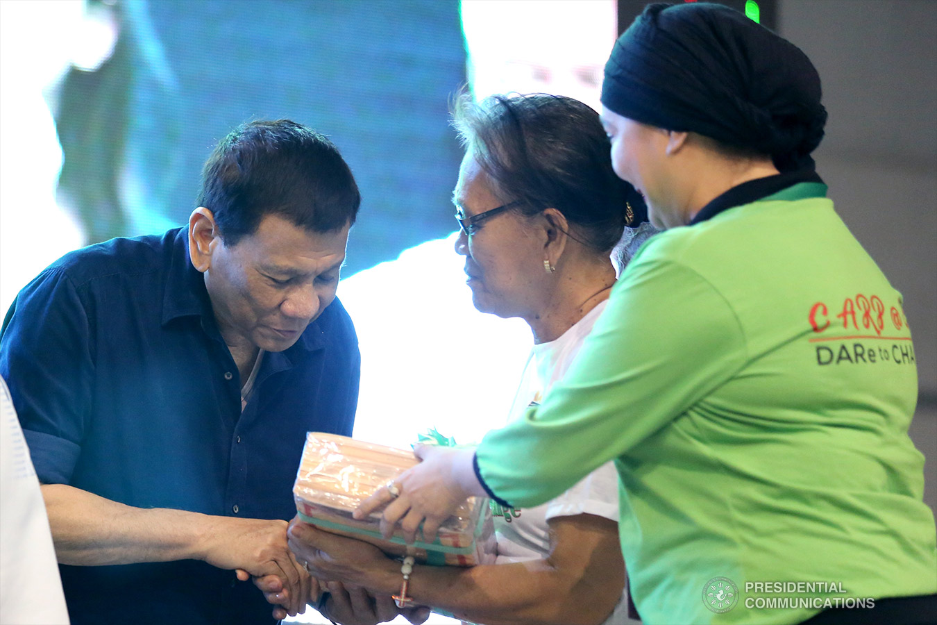 President Rodrigo Roa Duterte hands over the Certificates of Land Ownership Award (CLOAs) to the beneficiaries from Misamis Oriental and Camiguin represented by Norma Abrinica during a ceremony at the USTP Gymnasium, Claro M. Recto Avenue in Cagayan de Oro City on October 31, 2018. TOTO LOZANO/PRESIDENTIAL PHOTO