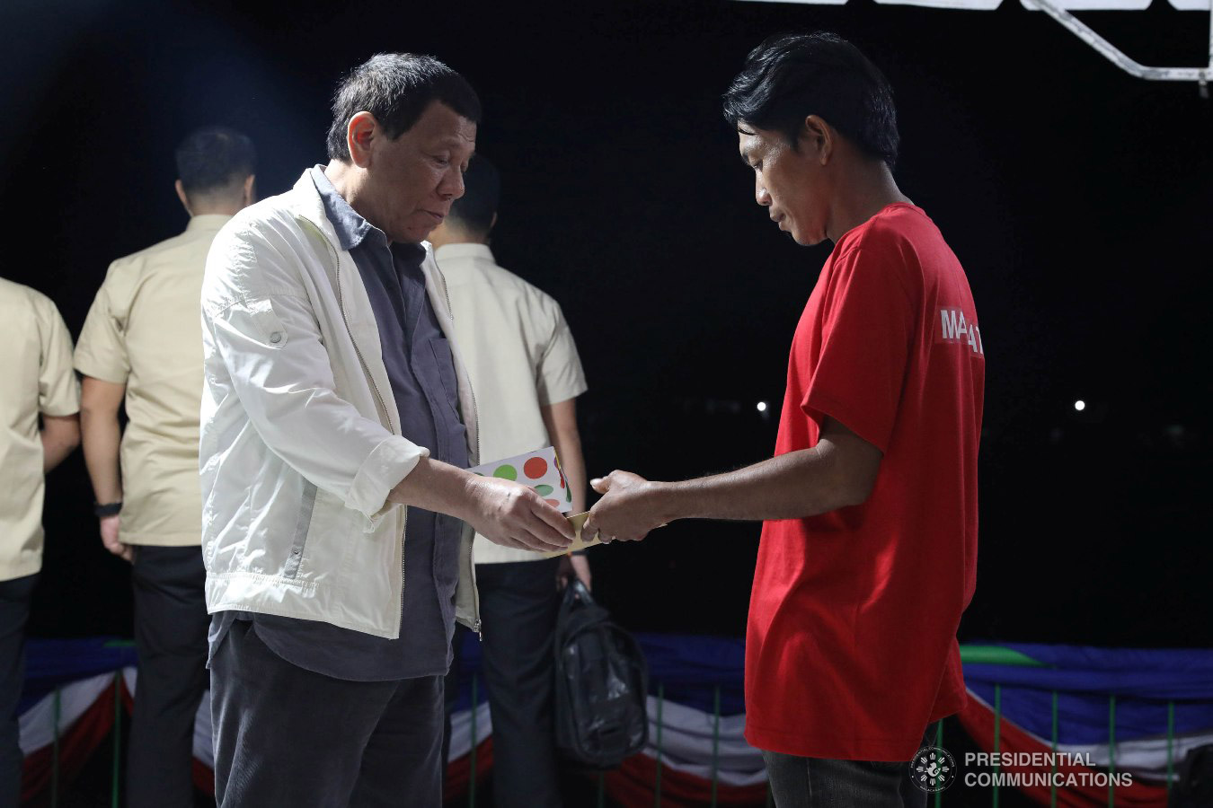 President Rodrigo Roa Duterte hands over a reintegration program package to a former New People's Army rebel who surrendered to the government during their formal surrender to the President held at the Cataingan National High School in Cataingan, Masbate on January 9, 2019. ACE MORANDANTE/PRESIDENTIAL PHOTO