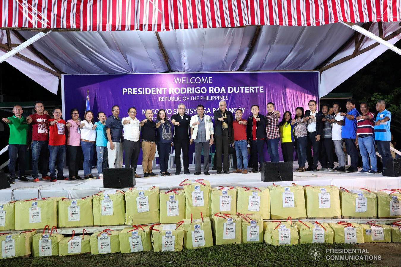 President Rodrigo Roa Duterte flashes his signature pose together with Trade and Industry Secretary Ramon Lopez, some local officials of Masbate, and other guests during the Negosyo Serbisyo sa Barangay held at the Patio Milagros Minitel and Resort in Dimasalang, Masbate on January 9, 2019. Also in the picture is former Special Assistant to the President Christopher Lawrence "Bong" Go. ACE MORANDANTE/PRESIDENTIAL PHOTO