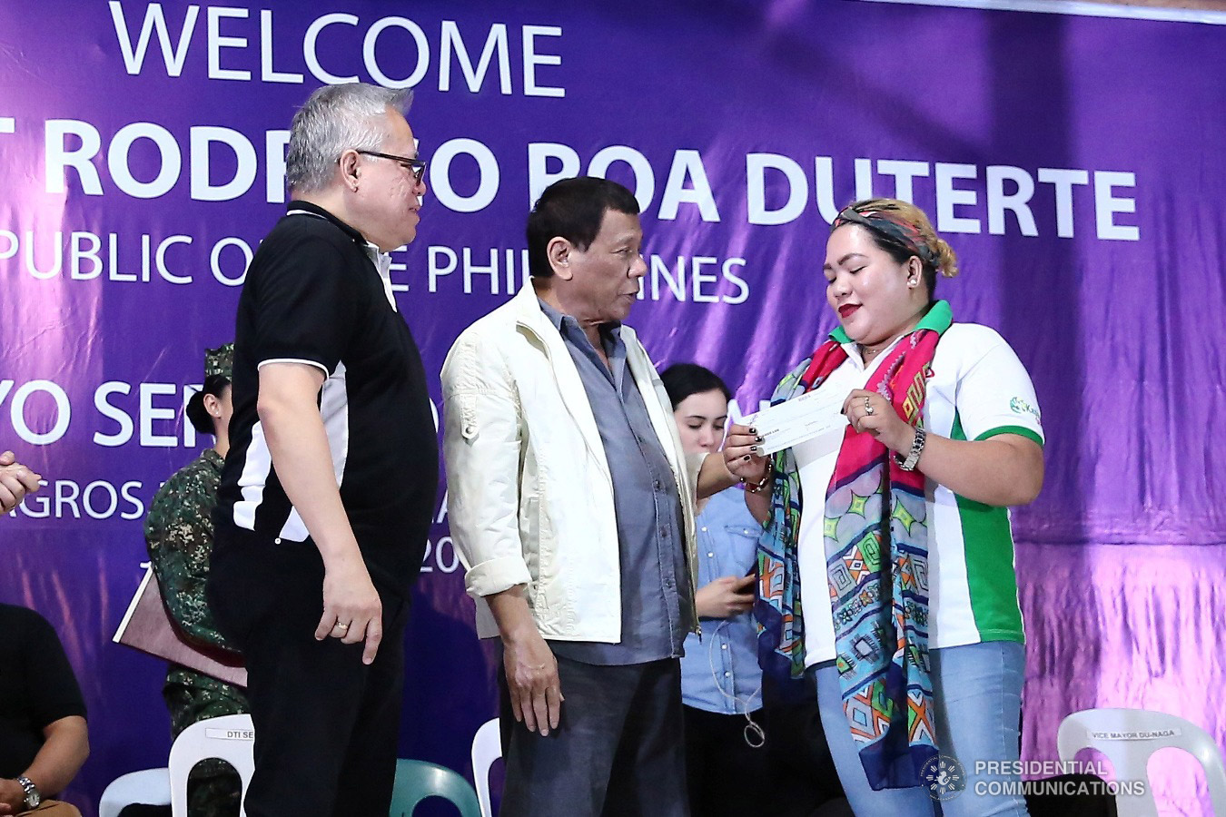 President Rodrigo Roa Duterte awards checks for loan beneficiaries during the Negosyo Serbisyo sa Barangay held at the Patio Milagros Minitel and Resort in Dimasalang, Masbate on January 9, 2019. Assisting the President is Trade and Industry Secretary Ramon Lopez. VALERIE ESCALERA/PRESIDENTIAL PHOTO