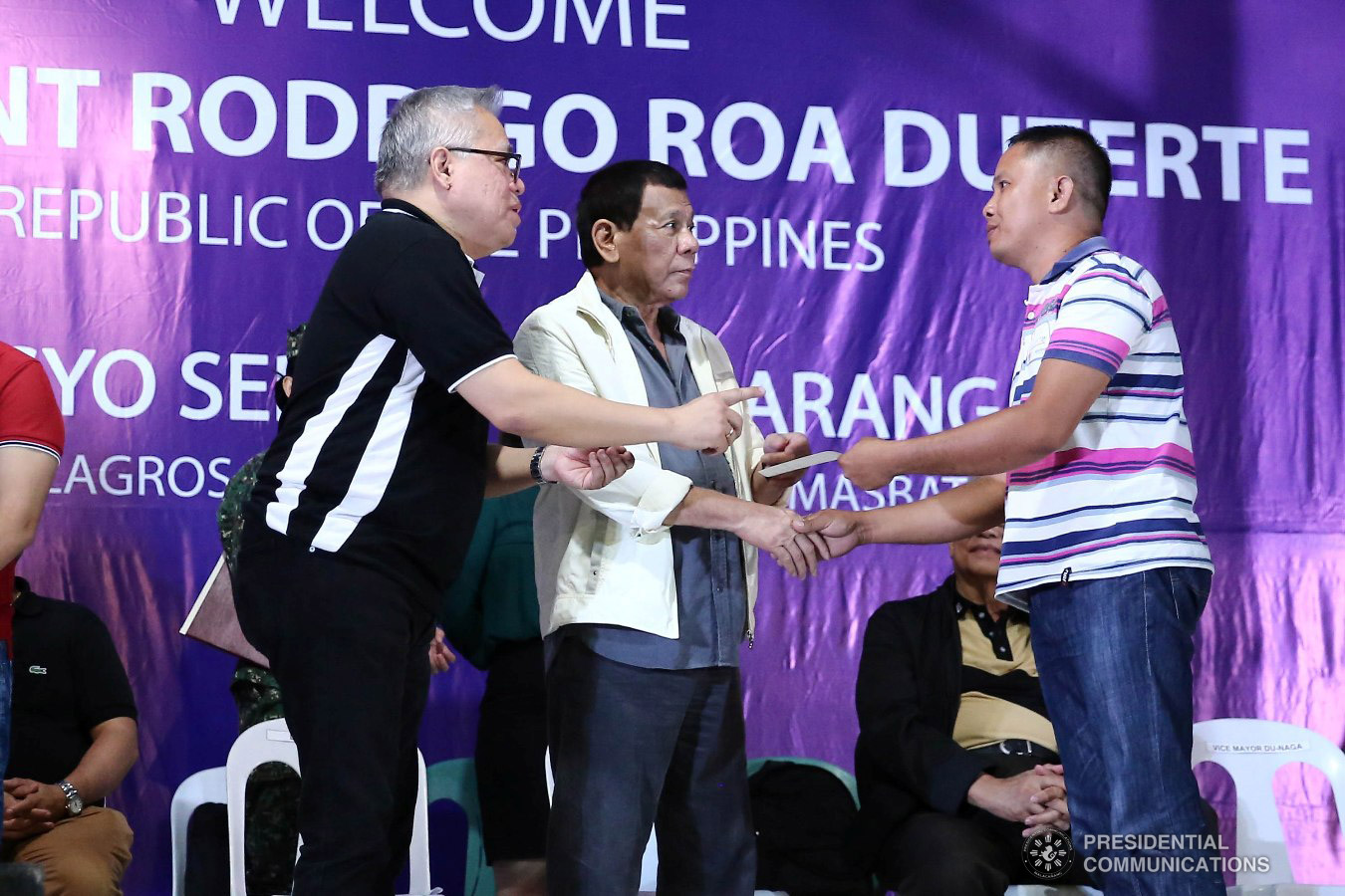 President Rodrigo Roa Duterte awards checks for loan beneficiaries during the Negosyo Serbisyo sa Barangay held at the Patio Milagros Minitel and Resort in Dimasalang, Masbate on January 9, 2019. Assisting the President is Trade and Industry Secretary Ramon Lopez. VALERIE ESCALERA/PRESIDENTIAL PHOTO