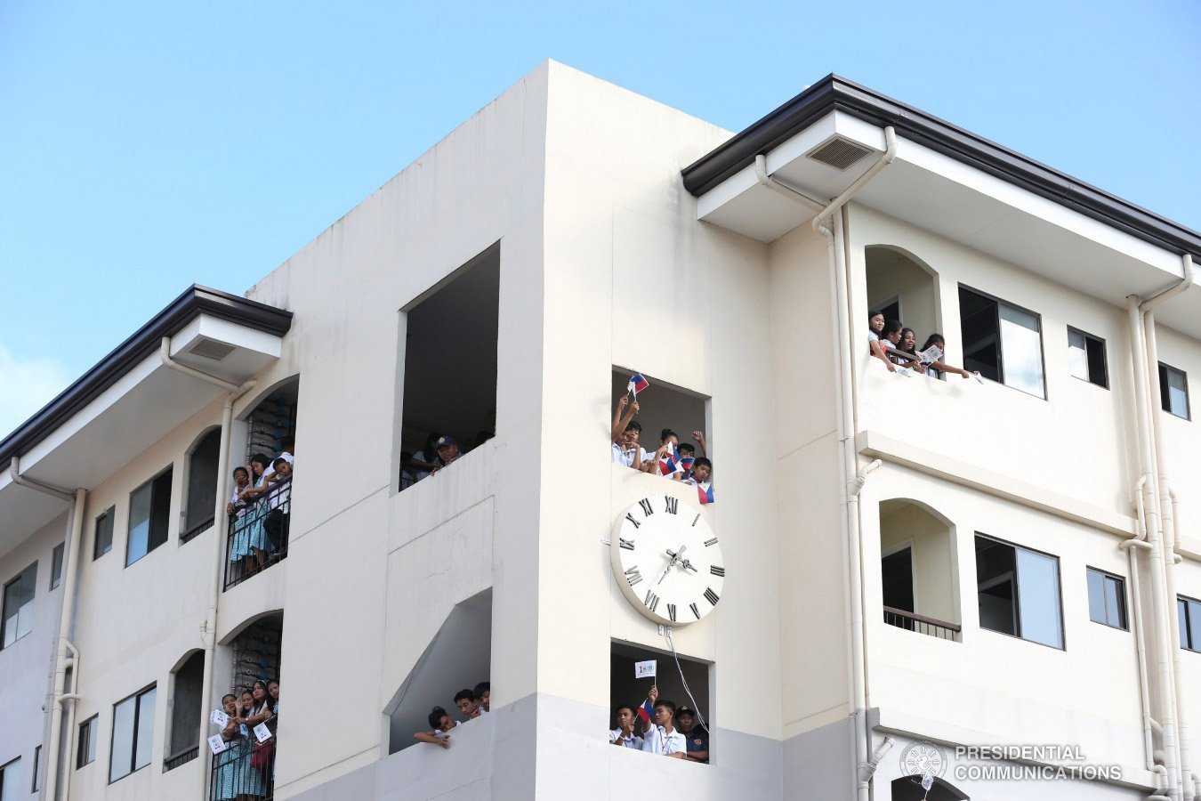 Students from a nearby school wait for the arrival of President Rodrigo Roa Duterte as he leads the ceremonial turnover of housing units to wounded police officers and soldiers at the Pleasant View Residences in the City of San Jose del Monte, Bulacan on January 10, 2019. TOTO LOZANO/PRESIDENTIAL PHOTO