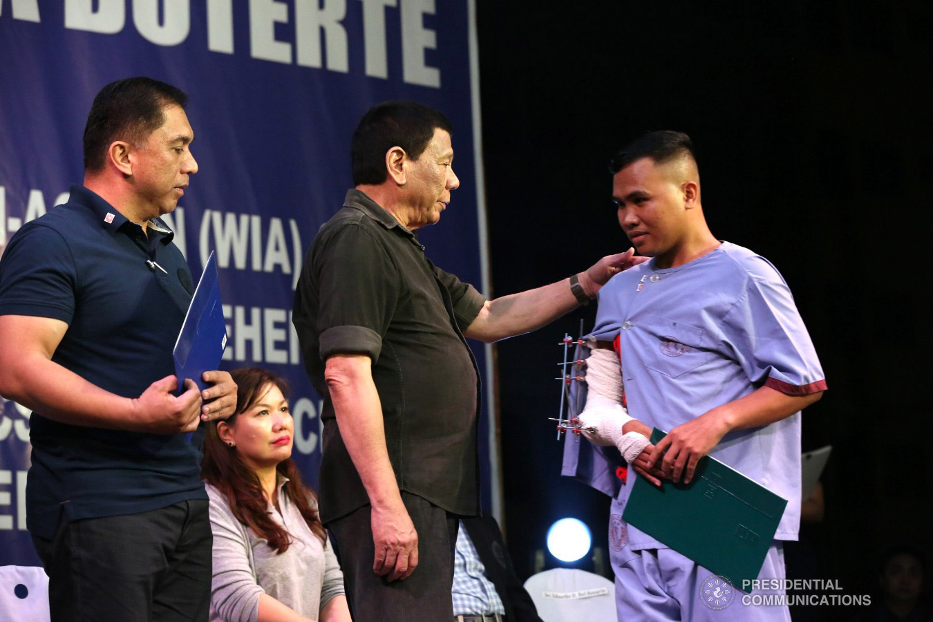 President Rodrigo Roa Duterte hands over a certificate of ownership to a wounded soldier who is one of the beneficiaries during the ceremonial turnover of housing units at the Pleasant View Residences in the City of San Jose del Monte, Bulacan on January 10, 2019. TOTO LOZANO/PRESIDENTIAL PHOTO