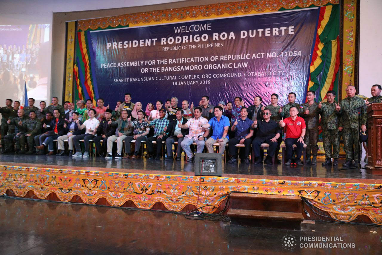 President Rodrigo Roa Duterte together with some members of his cabinet, officials from the Moro Islamic Liberation Front (MILF), Moro National Liberation Front (MNLF), some local officials, and other guests flash the "thumbs-up" sign as they have a picture taken for posterity during the Peace Assembly for the Ratification of Republic Act No. 11054 or the Bangsamoro Organic Law (BOL), held at the Shariff Kabunsuan Cultural Complex in Cotabato City on January 18, 2019. ROBINSON NIÑAL JR./PRESIDENTIAL PHOTO