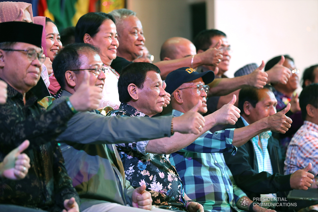 President Rodrigo Roa Duterte together with some members of his cabinet, officials from the Moro Islamic Liberation Front (MILF), Moro National Liberation Front (MNLF), some local officials, and other guests flash the "thumbs-up" sign during the Peace Assembly for the Ratification of Republic Act No. 11054 or the Bangsamoro Organic Law (BOL), held at the Shariff Kabunsuan Cultural Complex in Cotabato City on January 18, 2019. SIMEON CELI JR./PRESIDENTIAL PHOTO