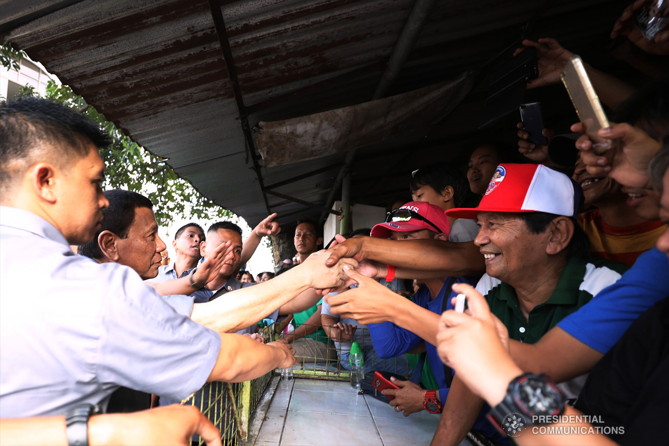 President Rodrigo Roa Duterte shakes hands with his supporters at the sidelines of the annual assembly of the Provincial Union of Leaders Against Illegality (PULI) at the Quezon Convention Center in Lucena City, province of Quezon on January 22, 2019. TOTO LOZANO/PRESIDENTIAL PHOTO