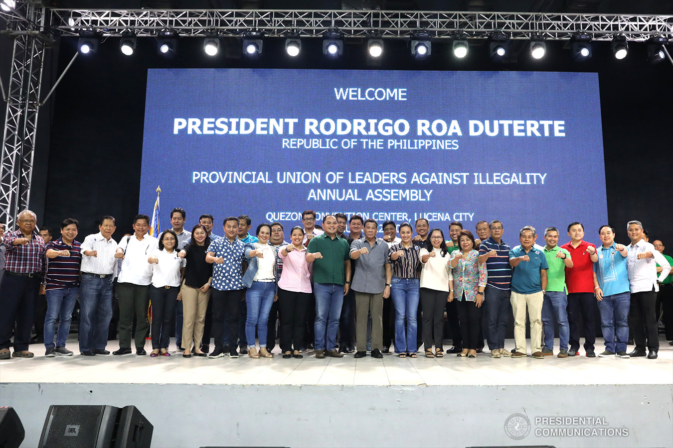 President Rodrigo Roa Duterte strikes his signature pose with Quezon Governor David Suarez and other distinguished guests during the annual assembly of the Provincial Union of Leaders Against Illegality (PULI) at the Quezon Convention Center in Lucena City, province of Quezon on January 22, 2019. ACE MORANDANTE/PRESIDENTIAL PHOTO