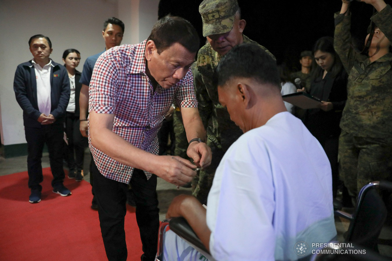 President Rodrigo Roa Duterte confers the Order of Lapu-Lapu Rank of Kampilan on one of the wounded soldiers he visited at Camp Evangelista Station Hospital in Cagayan de Oro City on January 25, 2019. KARL NORMAN ALONZO/PRESIDENTIAL PHOTO