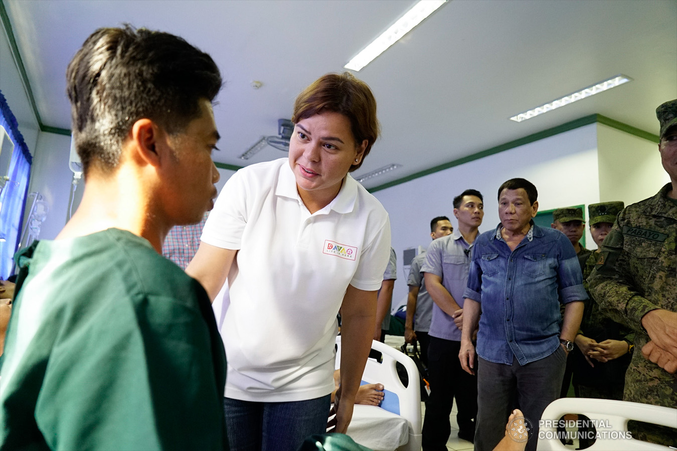 President Rodrigo Roa Duterte looks on as his daughter, Davao City Mayor Sara Duterte-Carpio, checks the condition of one of the wounded soldiers during their visit to Camp Teodulfo Bautista in Jolo, Sulu on January 28, 2019. The President personally checked the condition of the soldiers who were wounded during the twin bombings at the Cathedral of Our Lady of Mount Carmel in Jolo, Sulu last January 27. KING RODRIGUEZ/PRESIDENTIAL PHOTO