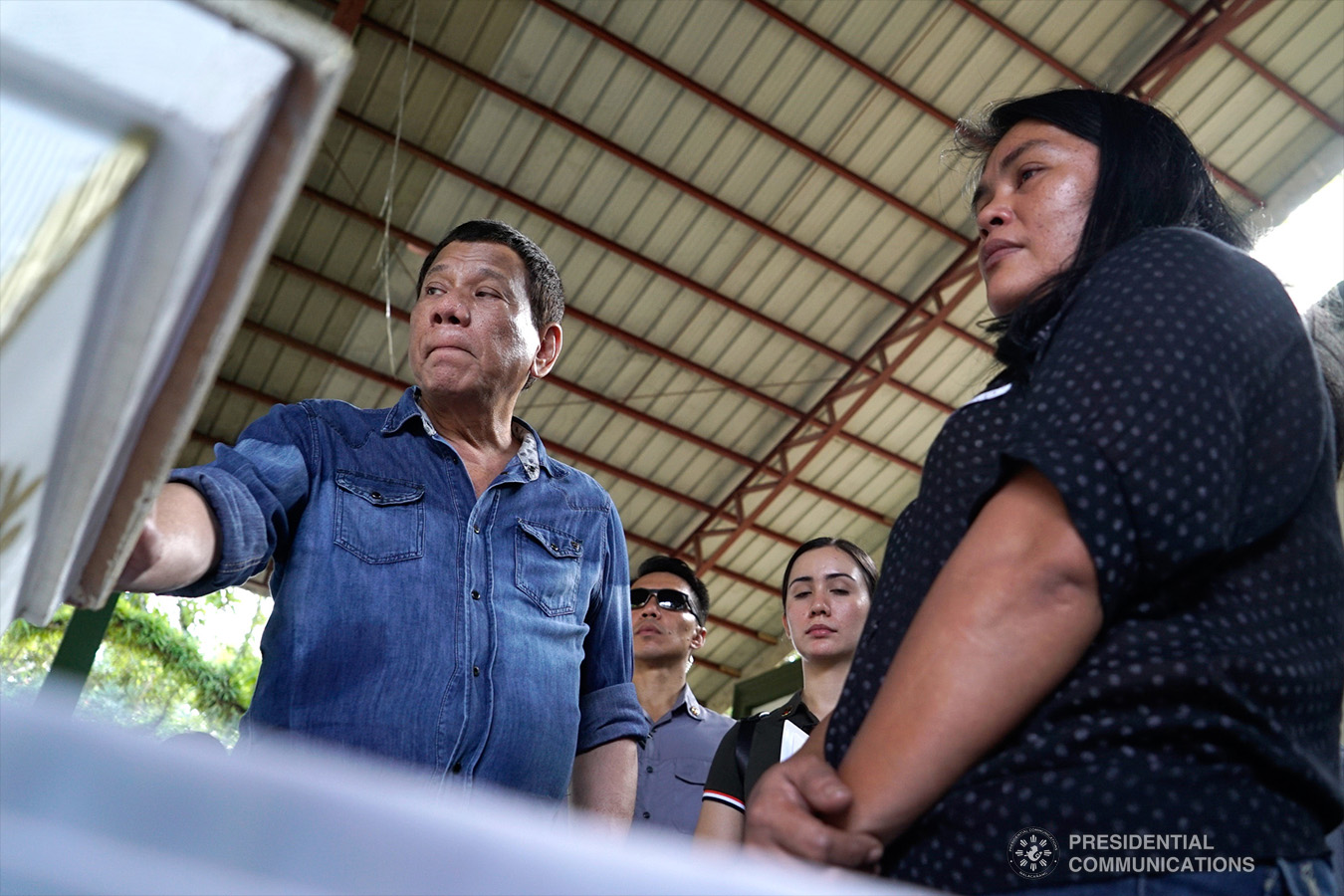 President Rodrigo Roa Duterte commiserates with the relatives of one of the victims who died during the twin bombings at the Cathedral of Our Lady of Mount Carmel in Jolo, Sulu as he visited Camp Teodulfo Bautista in Jolo on January 28, 2019. KING RODRIGUEZ/PRESIDENTIAL PHOTO
