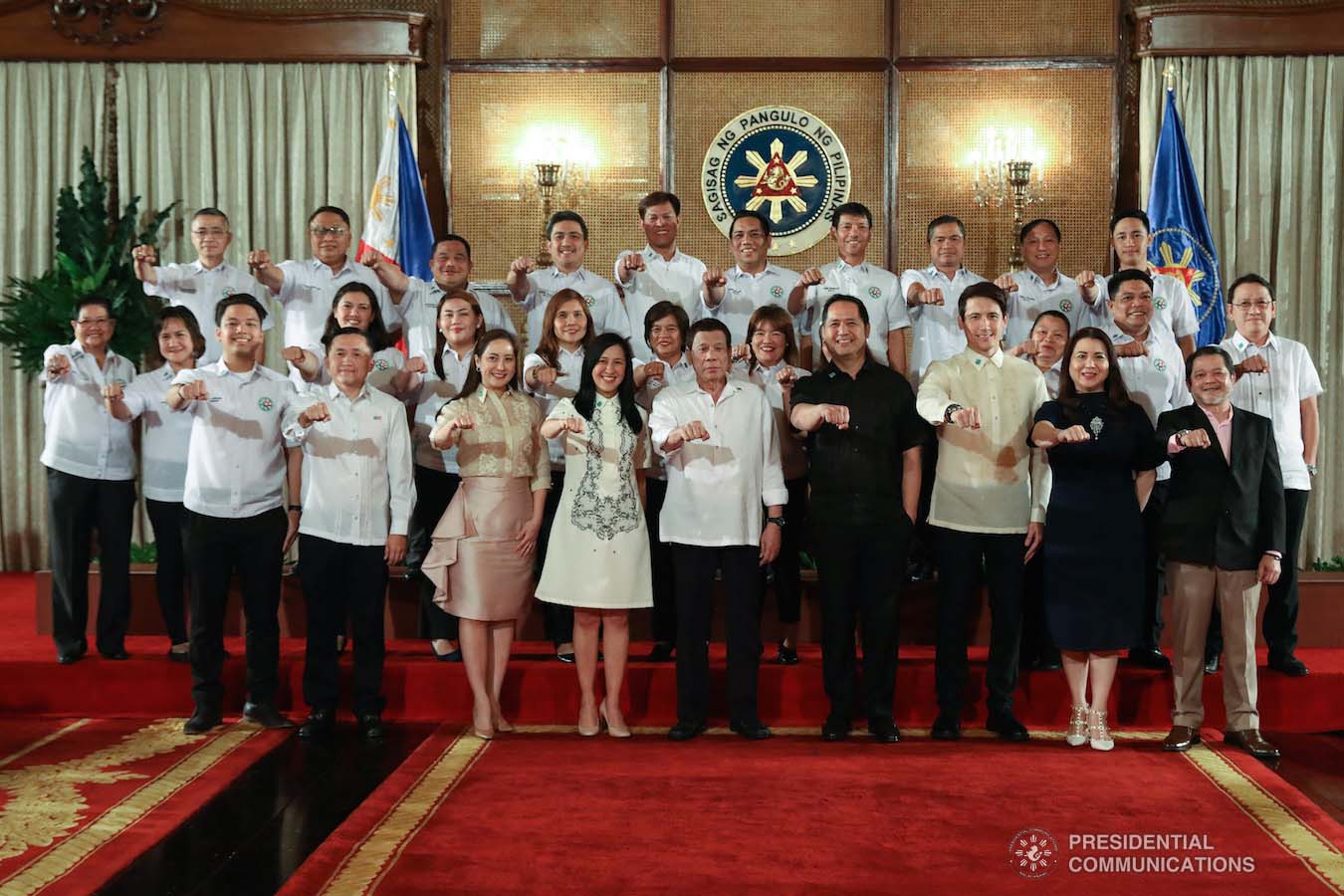 President Rodrigo Roa Duterte strikes his signature pose together with the Barangay Councilors from the Fourth District of Quezon City during a meeting at the Malacañan Palace on February 6, 2019. ROBINSON NIÑAL JR./PRESIDENTIAL PHOTO