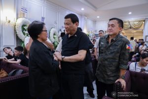 President Rodrigo Roa Duterte condoles with Minerva Lumawag, wife of the President's long-time friend and personal photographer Renato Lumawag, as he visits the wake at the Cosmopolitan Funeral Chapel in Davao City on July 3, 2019. With the President is Senator Christopher Lawrence "Bong" Go. TOTO LOZANO/PRESIDENTIAL PHOTO