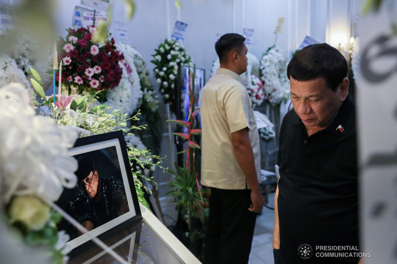 President Rodrigo Roa Duterte pays his last respects to his long-time friend and personal photographer Renato Lumawag at the Cosmopolitan Funeral Chapel in Davao City on July 3, 2019. TOTO LOZANO/PRESIDENTIAL PHOTO