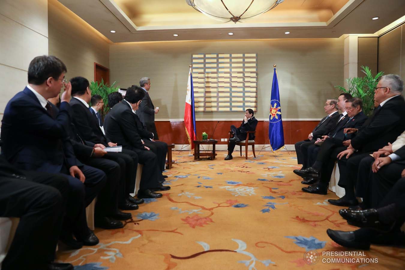 President Rodrigo Roa Duterte listens to the presentation of Cavite Governor Juanito Victor Remulla Jr. who paid a courtesy call on the President at the Grand Hyatt Hotel in Beijing on August 30, 2019. With Gov. Remulla are officials from CAVITEX Holdings, China Communication Construction Company, and China Airport Construction Group. KARL NORMAN ALONZO/ PRESIDENTIAL PHOTO