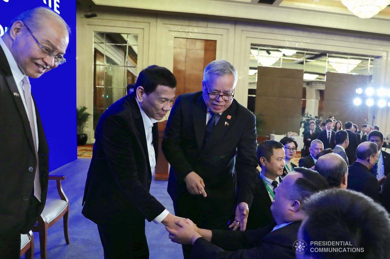 President Rodrigo Roa Duterte is accompanied by Trade and Industry Secretary Ramon Lopez as he interacts with the attendees during the Philippines-China Business Forum at the Grand Hyatt Hotel in Beijing on August 30, 2019. RICHARD MADELO/ PRESIDENTIAL PHOTO