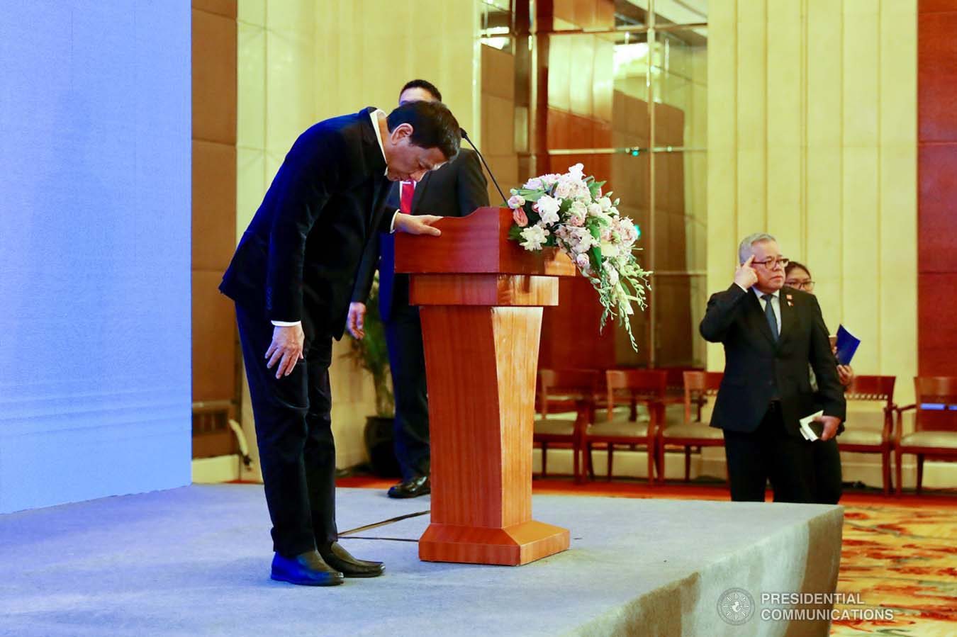 President Rodrigo Roa Duterte shows a gesture of respect as he takes center stage during the Philippines-China Business Forum at the Grand Hyatt Hotel in Beijing on August 30, 2019. RICHARD MADELO/ PRESIDENTIAL PHOTO