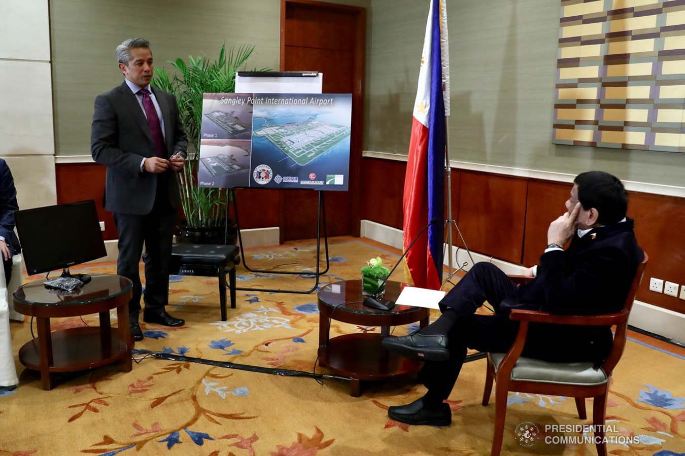 President Rodrigo Roa Duterte looks on as Cavite Governor Juanito Victor Remulla Jr. presents to him the architect's perspective of the Sangley Point International Airport during the courtesy call on the President at the Grand Hyatt Hotel in Beijing on August 30, 2019. RICHARD MADELO/ PRESIDENTIAL PHOTO