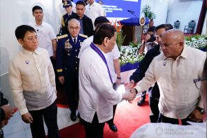 President Rodrigo Roa Duterte greets Senators Ronald dela Rosa and Francis Tolentino on the sidelines of the 118th Police Service Anniversary at Camp Brigadier General Rafael T. Crame in Quezon City on August 9, 2019. KING RODRIGUEZ/PRESIDENTIAL PHOTO