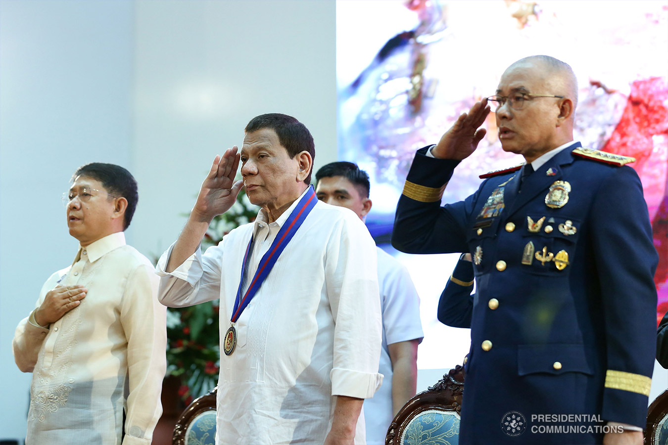President Rodrigo Roa Duterte sings the Philippine National Anthem during the 118th Police Service Anniversary at Camp Brigadier General Rafael T. Crame in Quezon City on August 9, 2019. With the President are Interior and Local Government Secretary Eduardo Año and Philippine National Police Chief Police General Oscar Albayalde. RICHARD MADELO/PRESIDENTIAL PHOTO