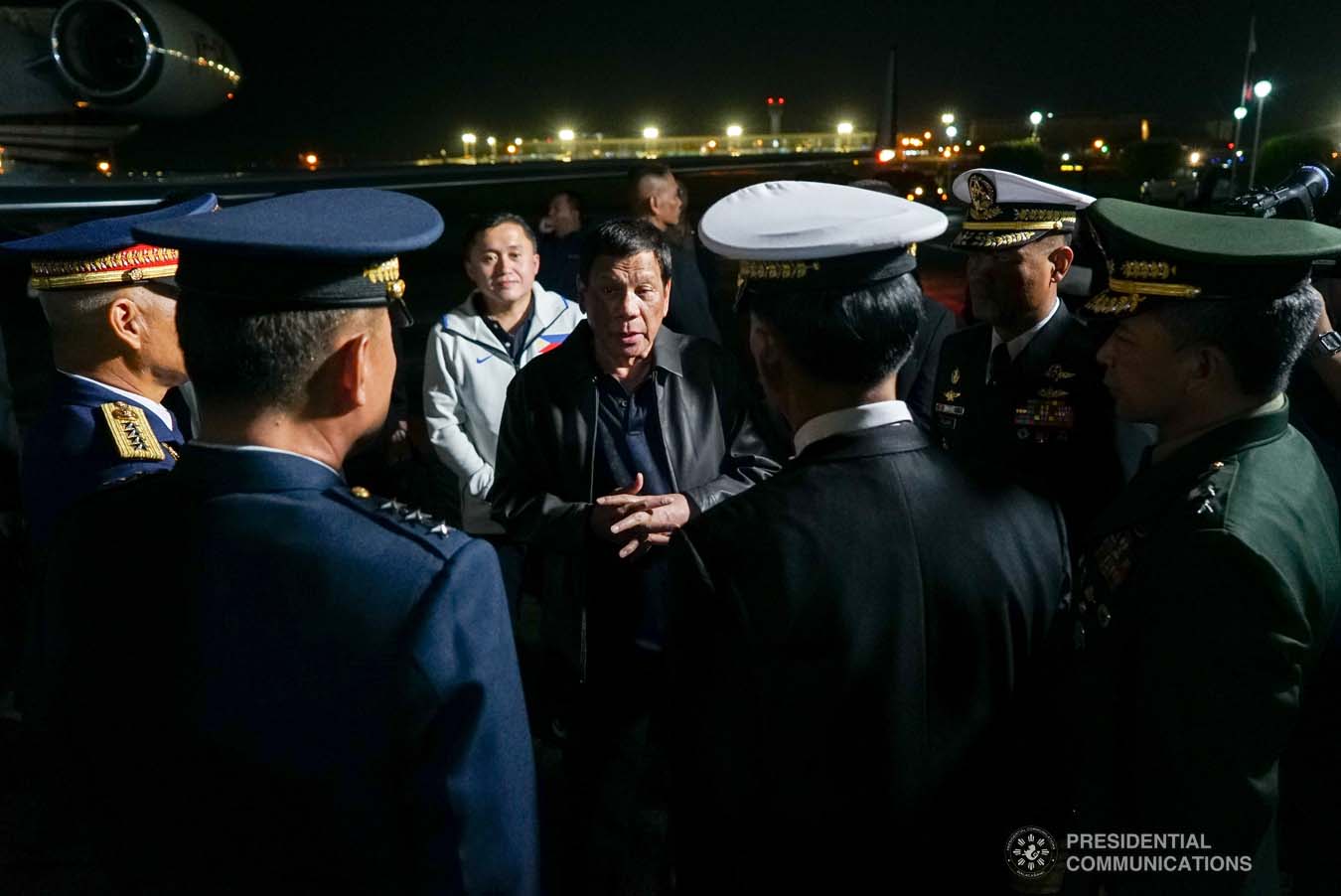 President Rodrigo Roa Duterte discusses matters with police and military officers upon his arrival at the Villamor Air Base in Pasay City on September 1, 2019 following his successful official visit to the People's Republic of China. KING RODRIGUEZ/PRESIDENTIAL PHOTO