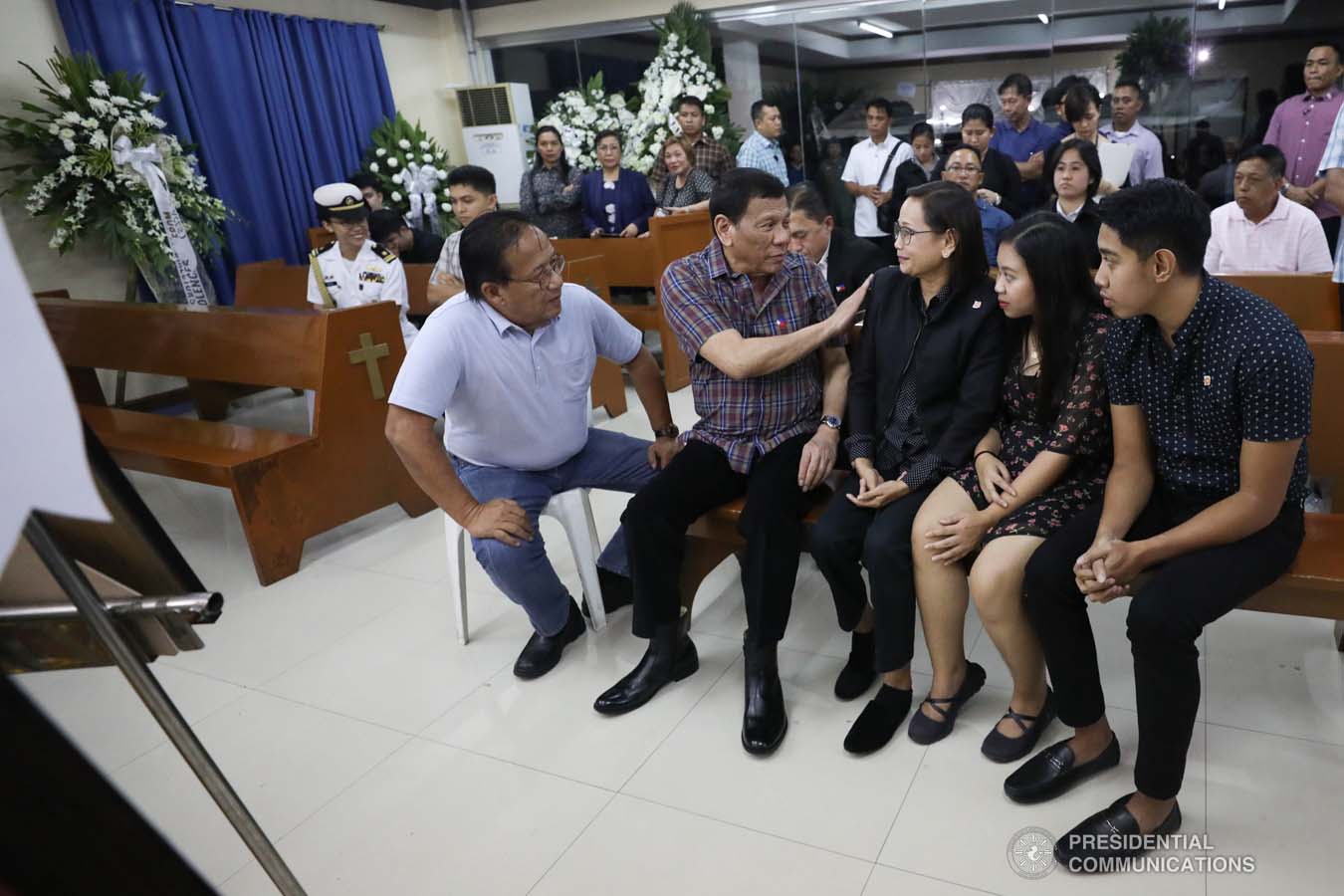 President Rodrigo Roa Duterte commiserates with the family of the late Captain Jesus Hernandez as he visits the wake at the Loyola Memorial Park in Parañaque City on September 5, 2019. Hernandez was the pilot of the Beechcraft King Air 350 with registry number RP-C2296 that crashed in Calamba City, Laguna last September 1. SIMEON CELI JR./PRESIDENTIAL PHOTO