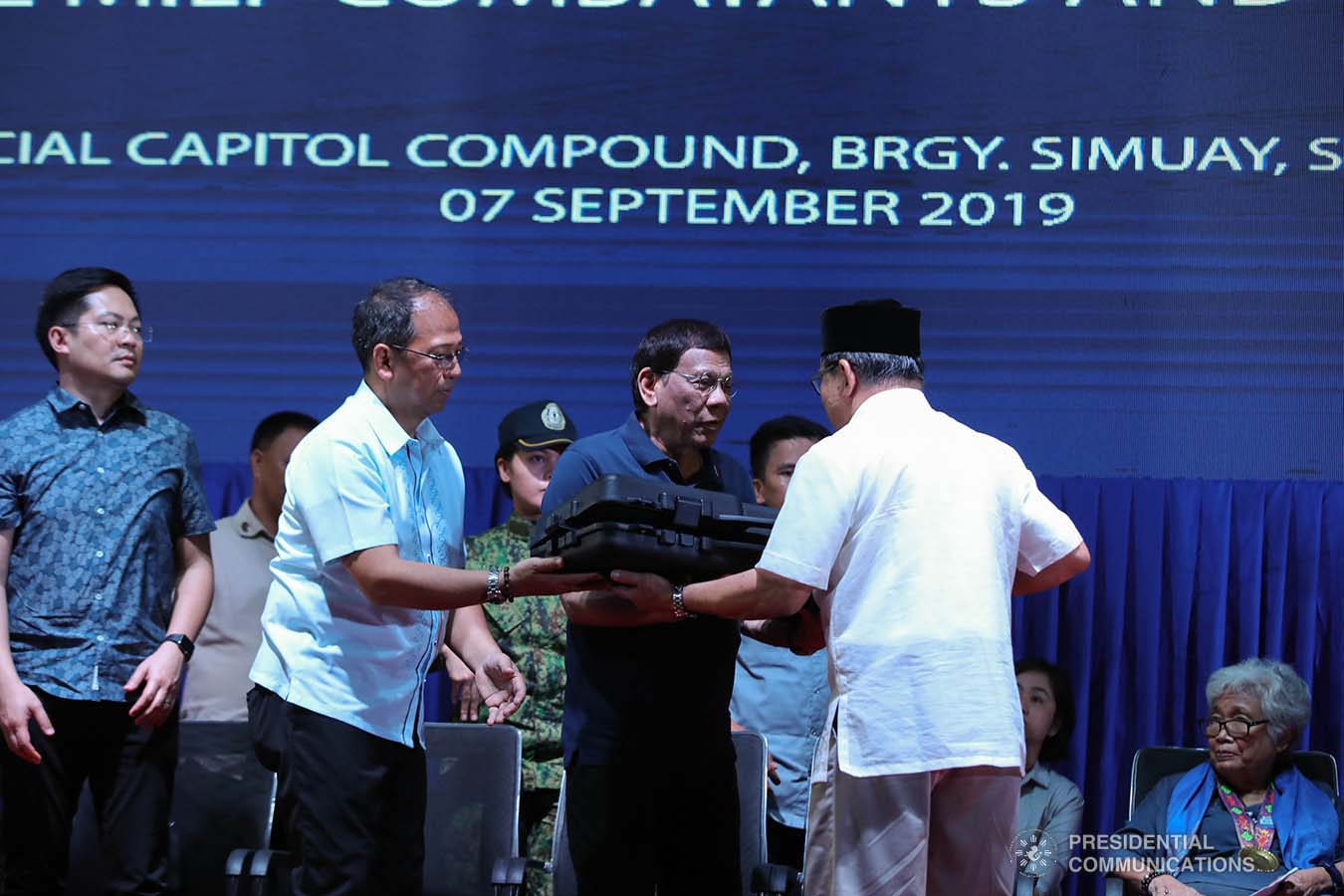 President Rodrigo Roa Duterte receives a token from Bangsamoro Autonomous Region in Muslim Mindanao (BARMM) Interim Chief Minister Al Haj Murad Ebrahim during the launch of the second phase of the decommissioning of Moro Islamic Liberation Front combatants and weapons at the Old Provincial Capitol Compound in Sultan Kudarat, Maguindanao on September 7, 2019. ROBINSON NIÑAL JR./PRESIDENTIAL PHOTO