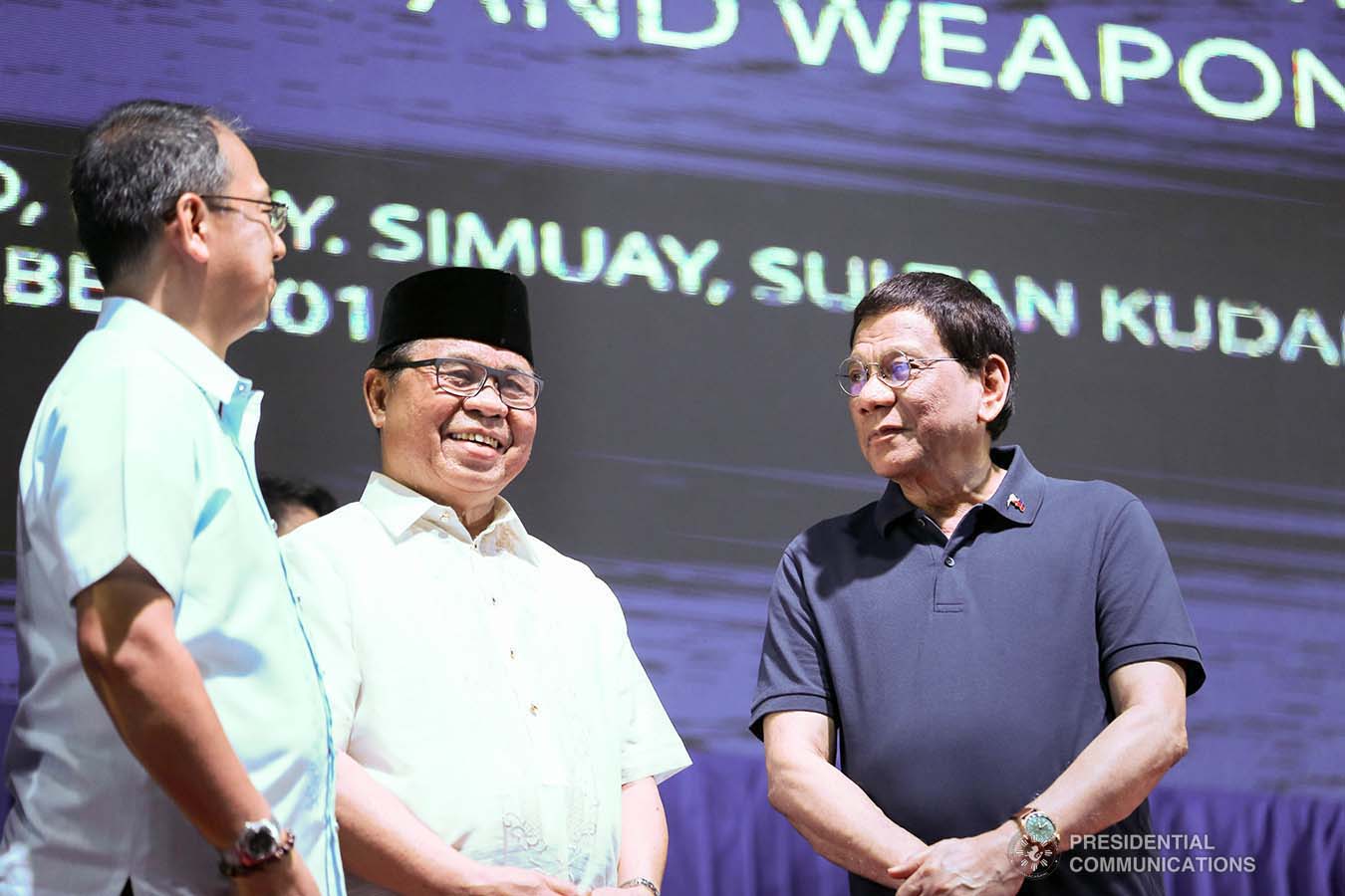 President Rodrigo Roa Duterte shares a light moment with Bangsamoro Autonomous Region in Muslim Mindanao (BARMM) Interim Chief Minister Al Haj Murad Ebrahim and Presidential Adviser on the Peace Process Carlito Galvez Jr. during the launch of the second phase of the decommissioning of Moro Islamic Liberation Front combatants and weapons at the Old Provincial Capitol Compound in Sultan Kudarat, Maguindanao on September 7, 2019. KARL NORMAN ALONZO/PRESIDENTIAL PHOTO