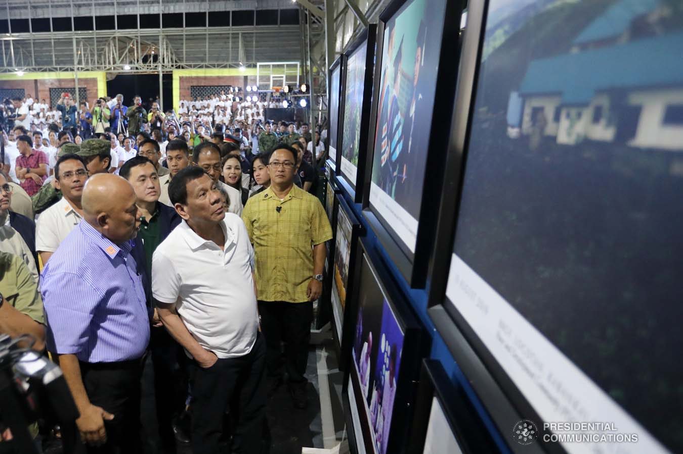 President Rodrigo Roa Duterte admires the photo gallery during the decommissioning of the arms and forces of the 727 Rebolusyonaryong Partido ng Manggagawa - Pilipinas/ Revolutionary Proletarian Army/ Alex Boncayao Brigade - Tabara-Paduano Group (RPM-P/RPA/ABB-TPG) at the Camp General Macario B. Peralta, Jr. in Jamindan, Capiz on September 19, 2019. ALFRED FRIAS/PRESIDENTIAL PHOTO