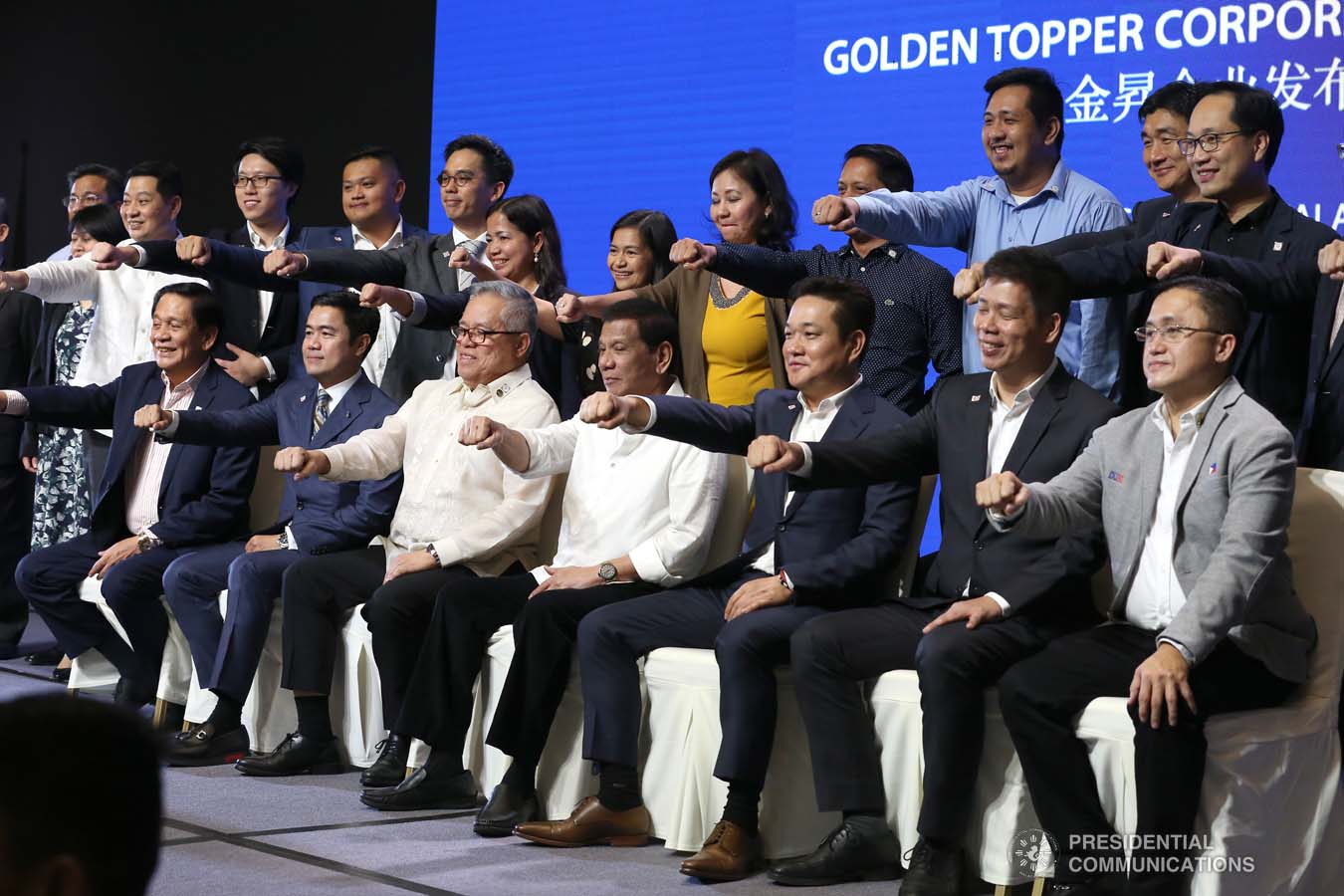 President Rodrigo Roa Duterte flashes his signature pose with the officials of the Golden Topper Group Inc. and other distinguished guests during the Golden Topper Corporate Launch at the Aseana Business Park in Parañaque City on September 25, 2019. ALBERT ALCAIN/PRESIDENTIAL PHOTO