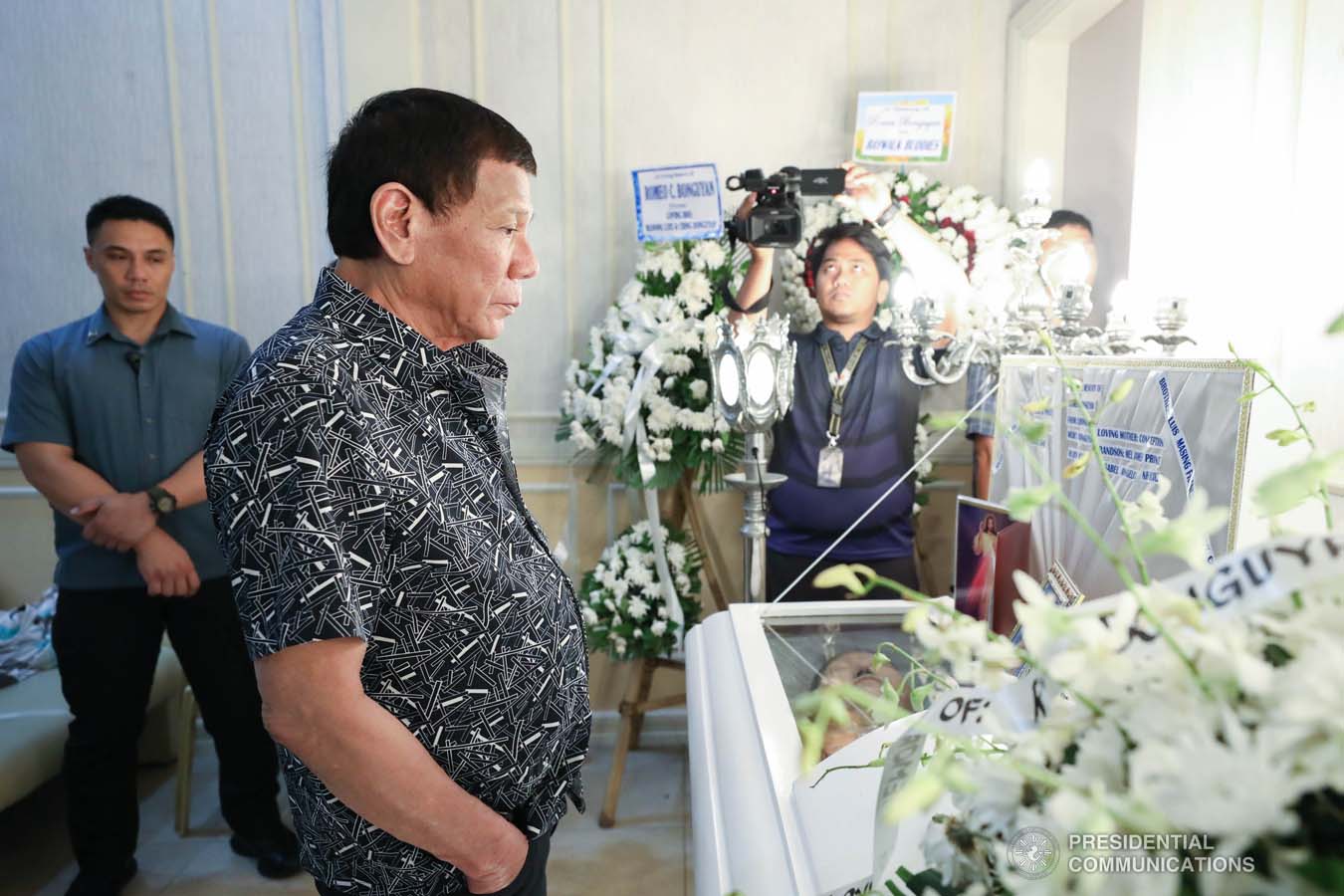 President Rodrigo Roa Duterte pays his last respects to Romeo Bonguyan as he visits the wake at the Cosmopolitan Funeral Homes in Davao City on September 26, 2019. RICHARD MADELO/PRESIDENTIAL PHOTO