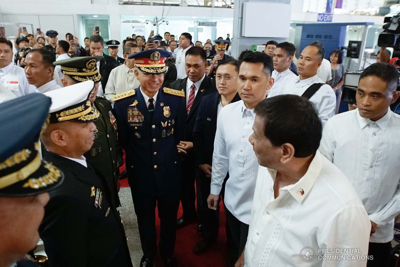 President Rodrigo Roa Duterte bids farewell to the police and military officials prior to his departure at the Ninoy Aquino International Airport in Pasay City on October 01, 2019 for his official visit to the Russian Federation. KING RODRIGUEZ/PRESIDENTIAL PHOTO