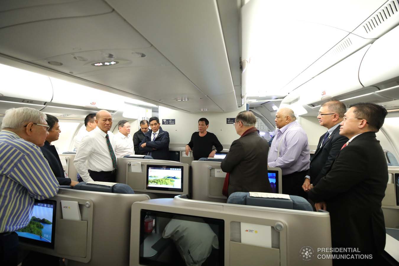 President Rodrigo Roa Duterte discusses matters with the members of his delegation while on board a plane bound for Sochi, Russia on October 2, 2019. KING RODRIGUEZ/PRESIDENTIAL PHOTO