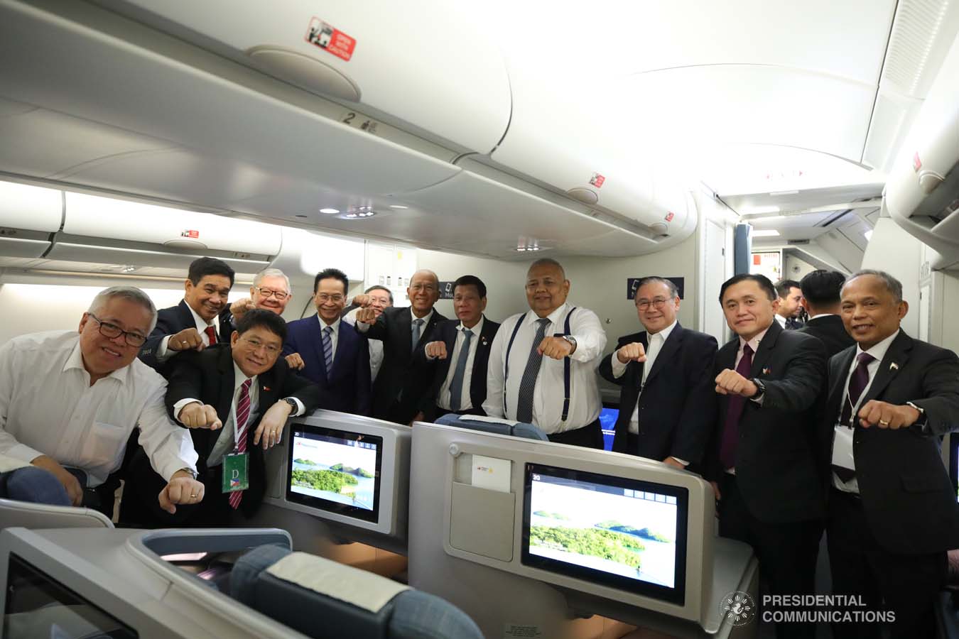 President Rodrigo Roa Duterte strikes his signature pose with the members of his delegation while on board a plane back to Moscow, Russia following his successful engagements in Sochi on October 3, 2019. KING RODRIGUEZ/PRESIDENTIAL PHOTO