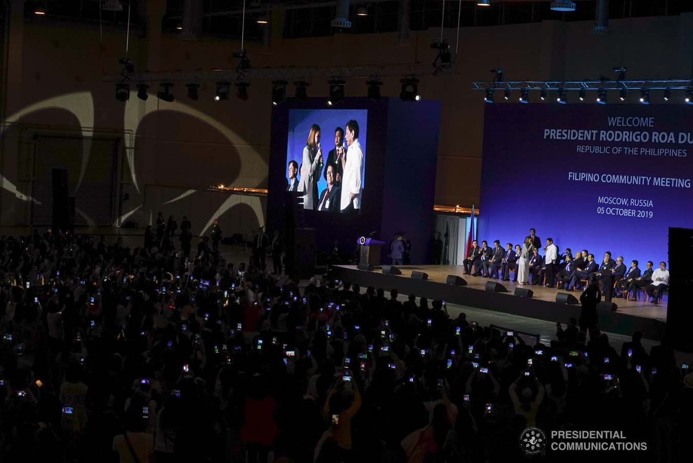 President Rodrigo Roa Duterte sings a duet with one of the performers during his meeting with the Filipino community at the Exhibition of Achievements of National Economy (VDNH) in Moscow on October 5, 2019. ROBINSON NIÑAL JR./PRESIDENTIAL PHOTO