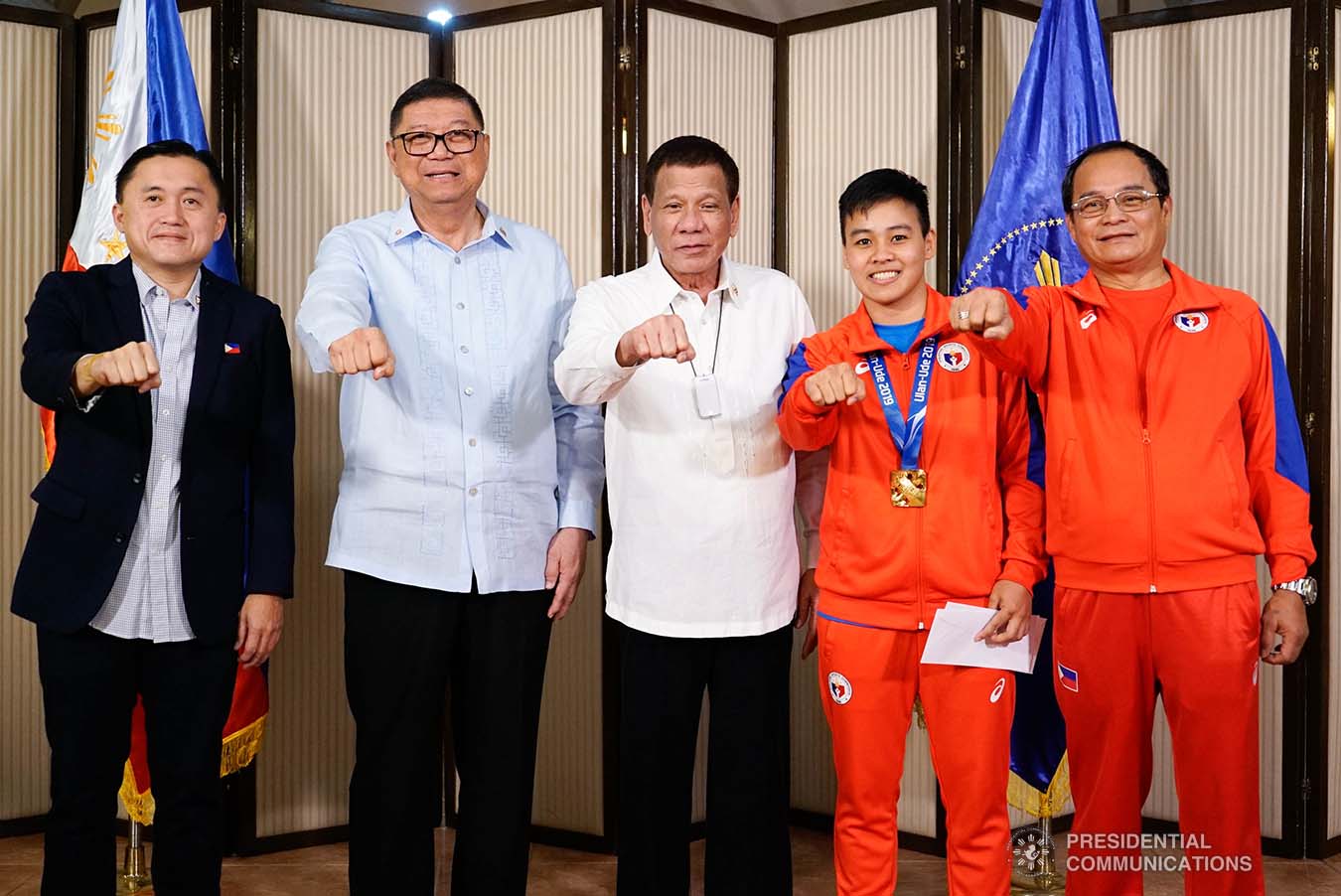 President Rodrigo Roa Duterte strikes his signature pose with 2019 AIBA Women's World Boxing Championships Gold Medalist Nesthy Petecio during their meeting at the Malago Clubhouse in Malacañang on October 16, 2019. Also in the photo are Senate Committee on Sports Chair Senator Christopher "Bong" Go and Philippine Sports Commission Chairman William Ramirez. KING RODRIGUEZ/PRESIDENTIAL PHOTO