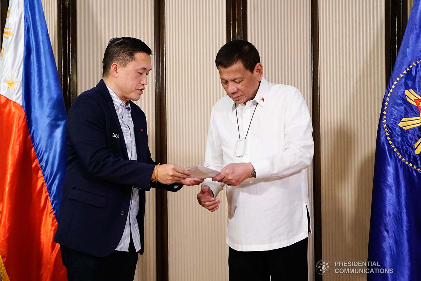 President Rodrigo Roa Duterte is assisted by Senate Committee on Sports Chair Senator Christopher "Bong" Go as he distributes the incentives to the Filipino athletes who have brought home medals from various international competitions during their meeting at the Malago Clubhouse in Malacañang on October 16, 2019. KING RODRIGUEZ/PRESIDENTIAL PHOTO