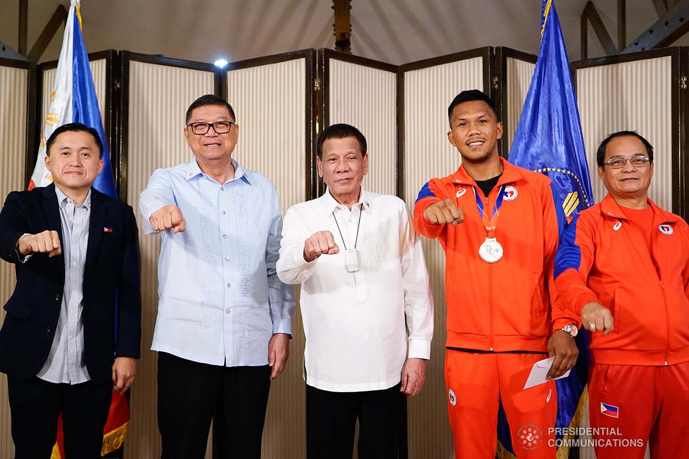 President Rodrigo Roa Duterte strikes his signature pose with 2019 AIBA Men's World Boxing Championships Silver Medalist Eumir Marcial during their meeting at the Malago Clubhouse in Malacañang on October 16, 2019. Also in the photo are Senate Committee on Sports Chair Senator Christopher "Bong" Go and Philippine Sports Commission Chairman William Ramirez. KING RODRIGUEZ/PRESIDENTIAL PHOTO
