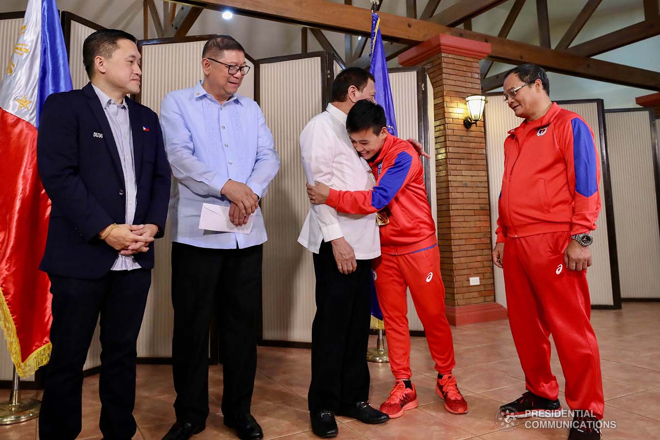 President Rodrigo Roa Duterte is embraced by 2019 AIBA Women's World Boxing Championships Gold Medalist Nesthy Petecio during their meeting at the Malago Clubhouse in Malacañang on October 16, 2019. RICHARD MADELO/PRESIDENTIAL PHOTO