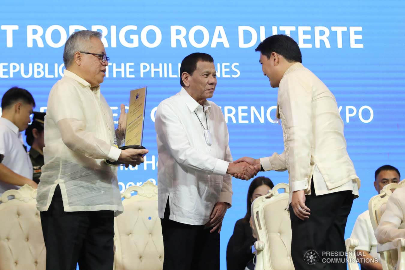 President Rodrigo Roa Duterte congratulates Cauayan City Mayor Bernard Dy as he receives the Most Business-Friendly LGU City Level 2 Award during the 45th Philippine Business Conference and Expo at The Manila Hotel on October 17, 2019. Assisting the President during the awarding ceremony is Trade and Industry Secretary Ramon Lopez. ROBINSON NIÑAL JR./PRESIDENTIAL PHOTO