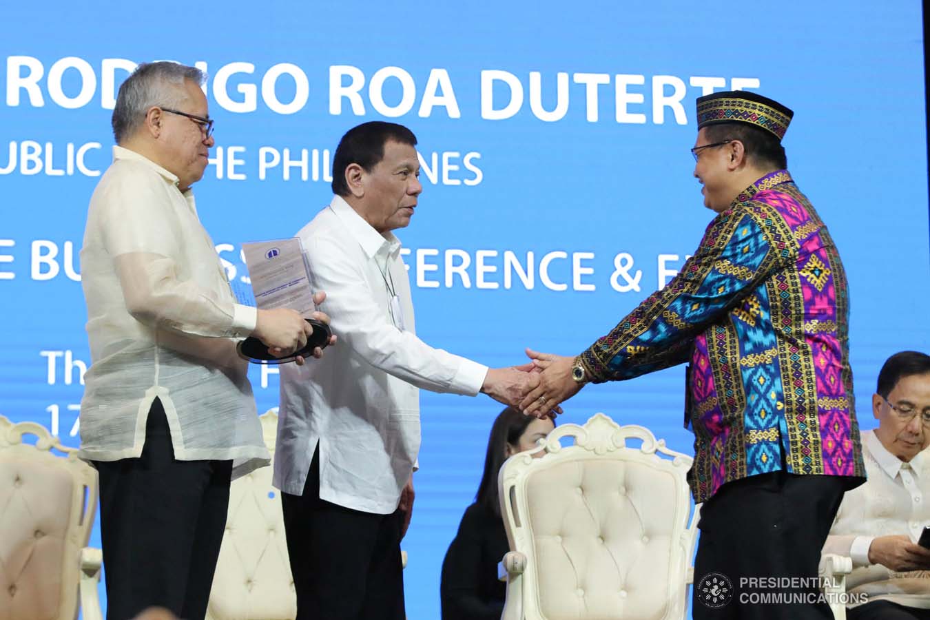 President Rodrigo Roa Duterte congratulates Philippine Chamber of Commerce and Industry (PCCI) Marawi President Abdul Rashid Macala as he receives the Most Outstanding Young Chamber Award during the 45th Philippine Business Conference and Expo at The Manila Hotel on October 17, 2019. Assisting the President during the awarding ceremony is Trade and Industry Secretary Ramon Lopez. ROBINSON NIÑAL JR./PRESIDENTIAL PHOTO