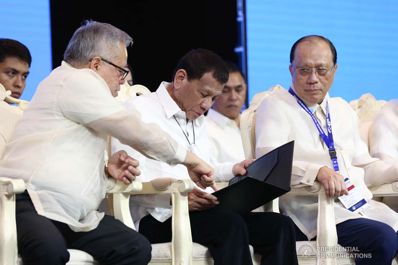 President Rodrigo Roa Duterte skims through the 45th Philippine Business Conference Resolutions presented by 45th Philippine Business Conference and Expo Chairman William Co during the awarding ceremony at The Manila Hotel on October 17, 2019. With the President is Trade and Industry Secretary Ramon Lopez. RICHARD MADELO/PRESIDENTIAL PHOTO