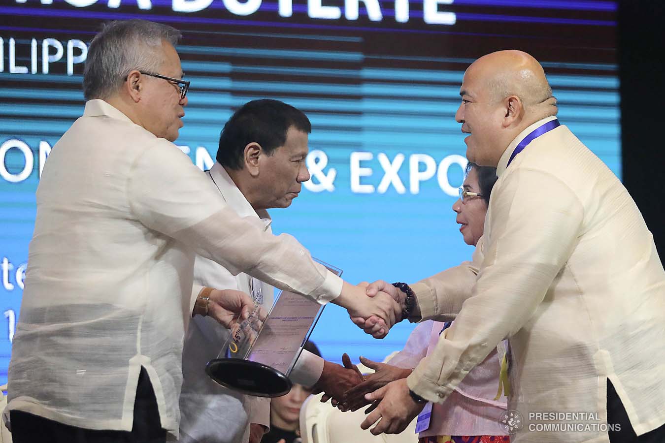 President Rodrigo Roa Duterte congratulates Camarines Chamber of Commerce and Industry President Hoover Picar as he receives the Most Outstanding Chamber South Luzon Provincial Level 1 Award during the 45th Philippine Business Conference and Expo at The Manila Hotel on October 17, 2019. Assisting the President during the awarding ceremony is Trade and Industry Secretary Ramon Lopez. VALERIE ESCALERA/PRESIDENTIAL PHOTO
